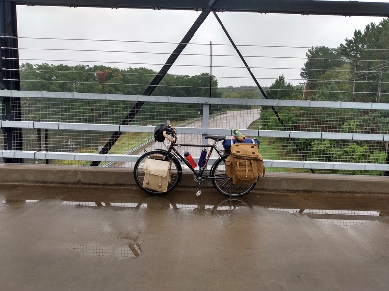 loaded bike on a rainy bridge