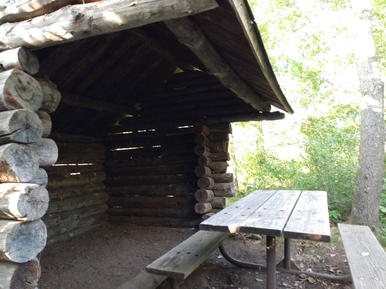 log shelter and picnic table